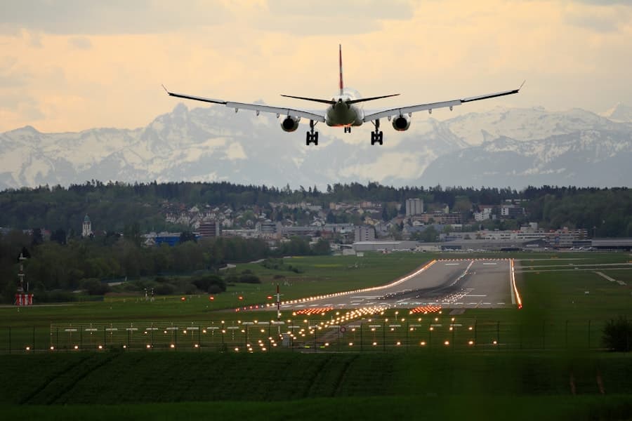 Commercial wide-body aircraft on final approach with landing gear down, mountains behind the airport — Airport & aerodrome services case study