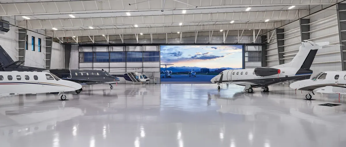 Interior of an FBO hangar with business aviation aircraft parked inside