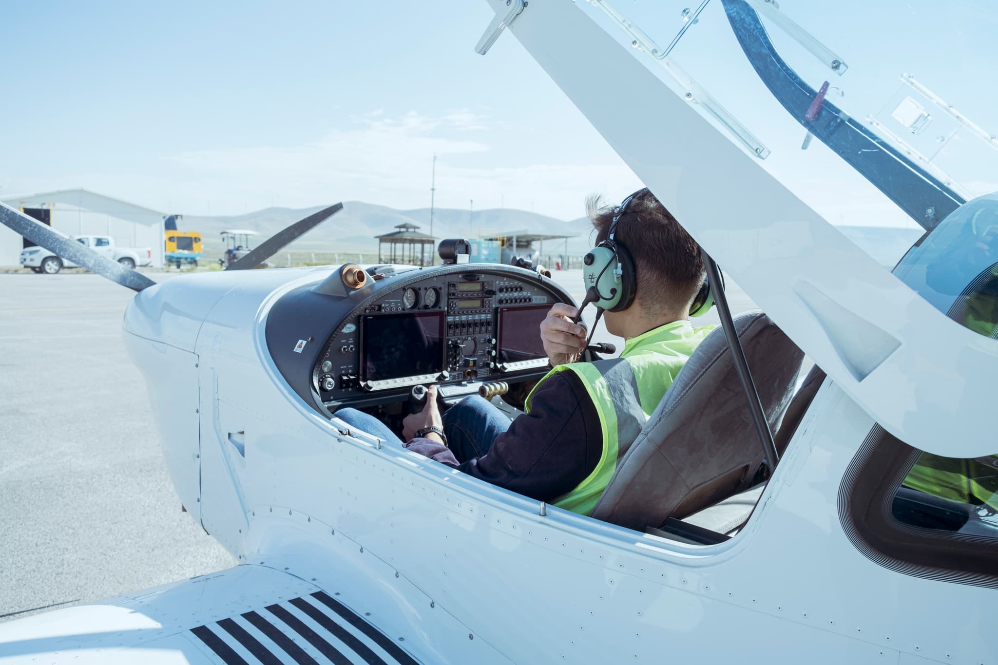 A pilot at the controls of a single-engine flight-training cockpit