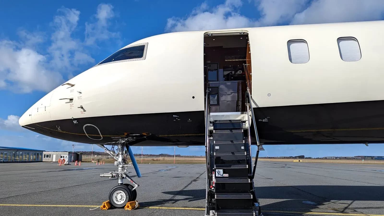 Business jet on the ramp with cabin door open and airstair deployed