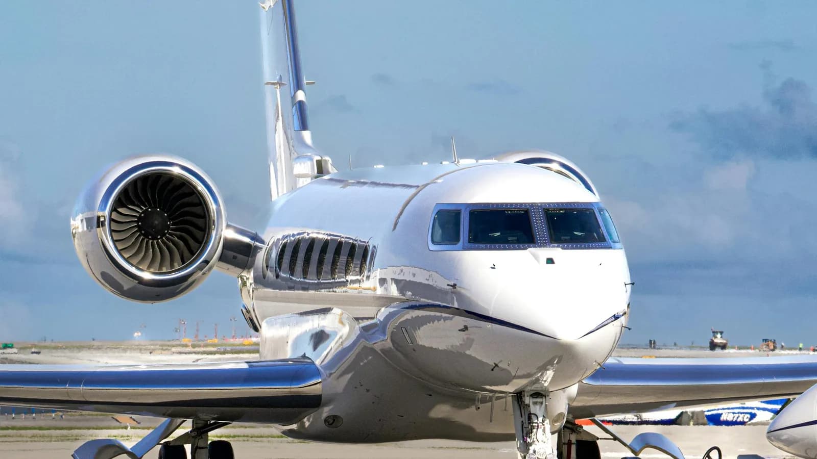 Business jet on the ramp with cabin door open between operator turns