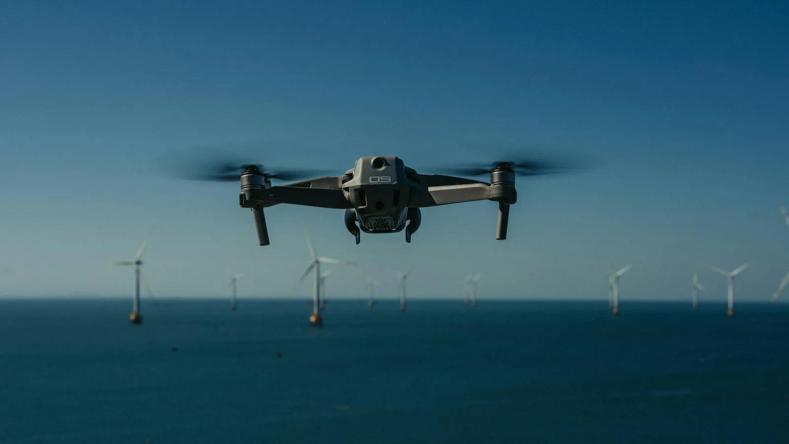Enterprise UAV deployed in front of a power-transmission tower for utility inspection