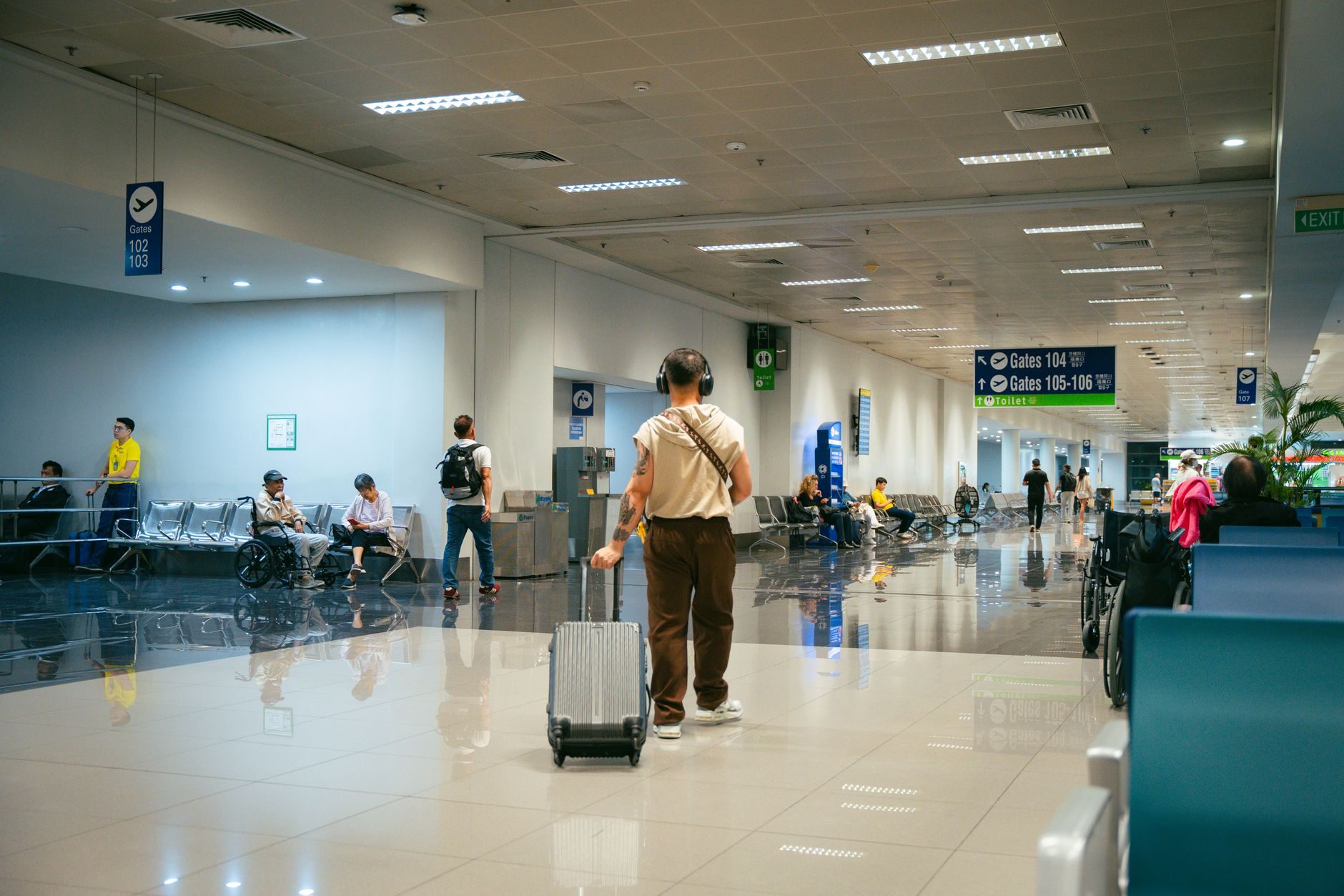 Travelers with different journeys moving through a bright modern airport terminal